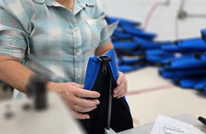 woman putting together sewn pouch